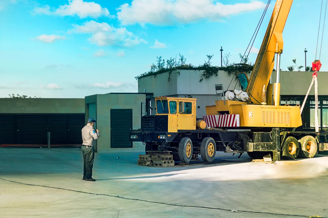 Elemento de JMA supervisando maniobras junto a una grúa en un sitio industrial